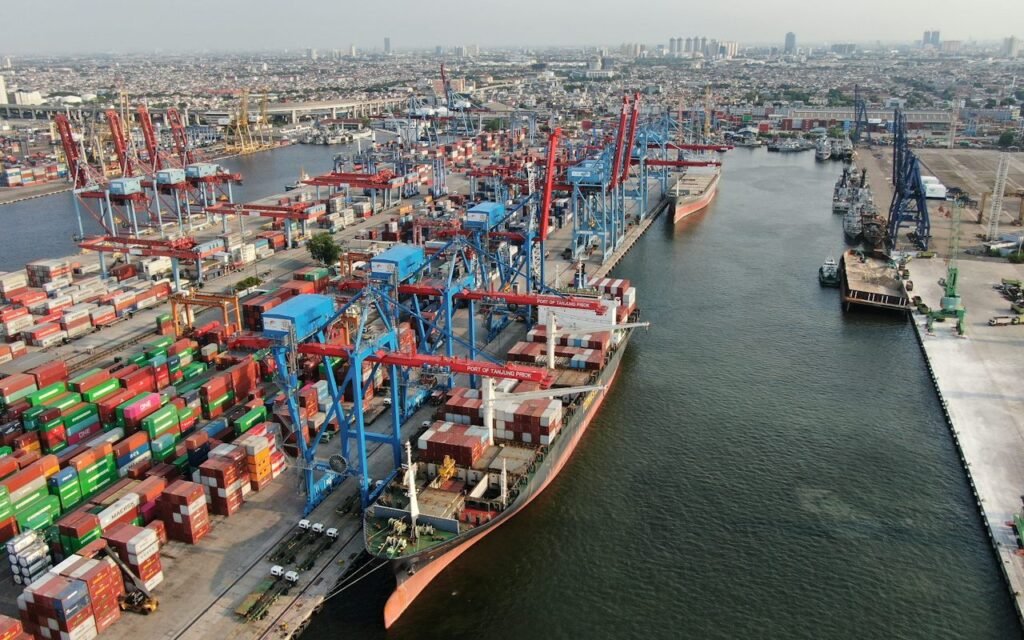 Aerial view of cargo ships, cranes and containers at a port for an article on bulk lubricant import planning